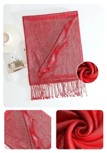 Red metallic tassel scarf detail view, showing the sparkling fabric texture and exquisite fringe.