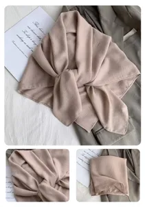 Detailaufnahme eines einfarbigen Baumwoll-Leinen-Schals mit feiner Textur und Faltung.
