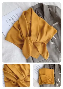 Detailansicht des einfarbigen gelben Schals mit weicher Stofftextur und elegantem Design.