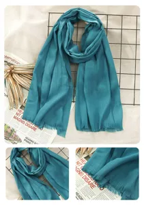 Detailed view of teal cotton linen fringed scarf, showcasing soft texture and edge design.