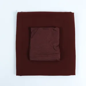 Detailed view of the dark maroon chiffon long hijab scarf and inner cap set nicely.