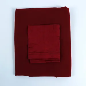 Close-up detail of the dark red chiffon long scarf and inner cotton cap set, soft fabric texture.