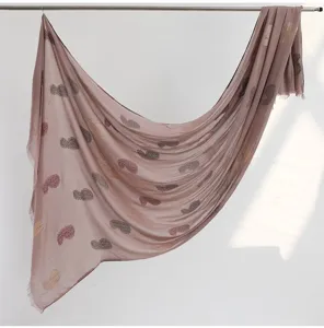Detail shot of dusty pink cotton linen paisley print fringed scarf shawl for women styling.