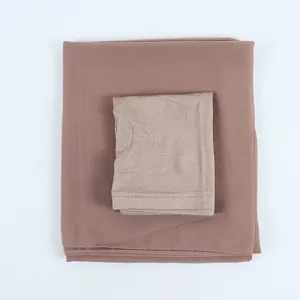 Chiffon hijab scarf set with matching inner cap in dusty pink, detail view of folded textile.