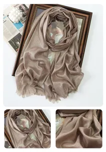 Detail view of metallic glitter long scarf, shimmering rayon fabric with delicate fringe.