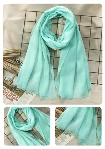 Mint green cotton linen scarf detail showing tassel fringe and soft fabric texture closeup view