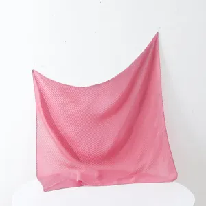 Close up of the pink pleated square scarf showing delicate texture and elegant drape style.