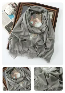 Detailed view of the shimmering metallic grey long scarf, showing soft draped texture.