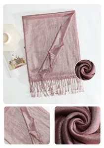 Detailed close-up view of the metallic shimmer scarf showing soft fabric texture and fringe.