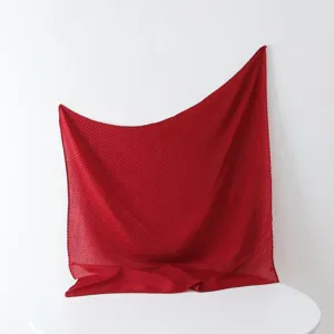 Solid red pleated square scarf detailed view, featuring fine texture and elegant drape style.