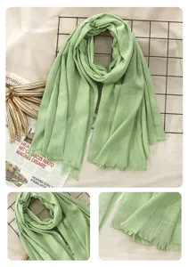 Detailed view of the light green cotton linen scarf showing soft fabric texture and fine fringes.
