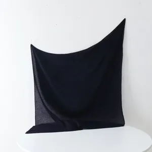 Black pleated scarf detail showing delicate texture and fine folds for elegant wear.