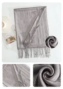 Detail view of the shimmering metallic grey scarf fabric texture and delicate fringe trim.