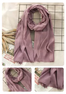 Detailed view of purple cotton linen scarf with fringe, vintage style flat lay scene.