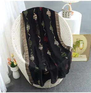 Detailed view of a stylish black cut-flower print linen blend fringed edge scarf shawl.