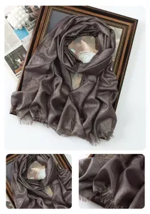 Close-up detail of the metallic shimmering long scarf showing fine texture and delicate fringe.