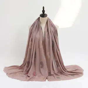 Elegant dusty pink cotton linen scarf with elegant printed floral motifs and fringed hem design.