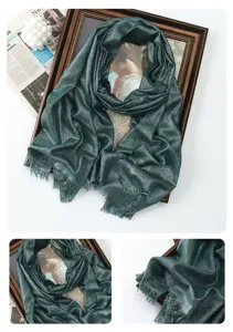 Close-up detail of the shimmering dark green metallic long scarf with delicate fringe edges.