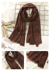 Detailed close-up view of a solid color linen scarf featuring elegant fringe trim design.