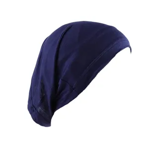 Detail view of the solid color stretchy inner hijab cap in dark blue, comfortable rayon fabric.