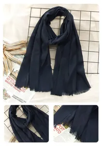 Detailed view of the dark blue linen autumn winter scarf featuring elegant fringe trim.