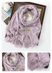 Shimmering metallic long scarf detail shot showing elegant purple color and delicate fringe edge.