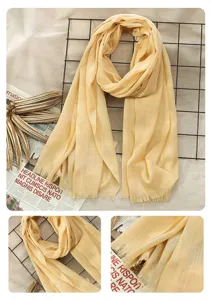 Lightweight linen cotton solid color scarf with delicate fringe detail, elegant draped look.