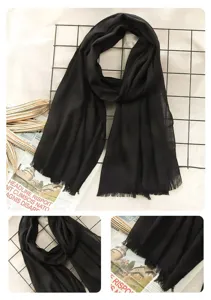 Detailed view of solid black cotton linen scarf, elegant autumn winter women neckwear accessory.