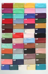 Detailed view of solid color fabric scarf swatches showing multiple vibrant color options.