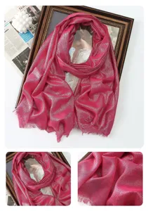 Close-up detail of shiny pink metallic scarf with fringe and soft rayon texture.