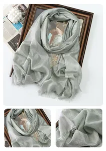 Metallic shiny long scarf detail view, shimmering fabric texture and delicate fringe trim.