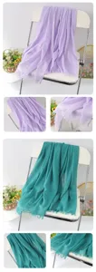 Solid color linen scarf shawl detail close-up, fringe design, elegant autumn winter fashion.