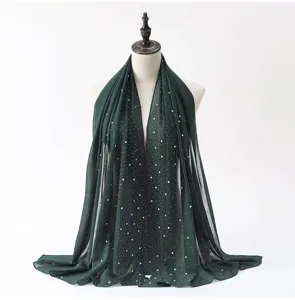 Dark green chiffon hijab scarf with pearls and rhinestones, detailed view of the elegant shawl.