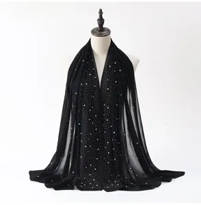 Detailed view of the black chiffon hijab featuring sparkling rhinestone and pearl embellishments.