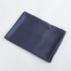 Dark blue satin fabric detail shot, smooth shiny texture, elegant textile material display.