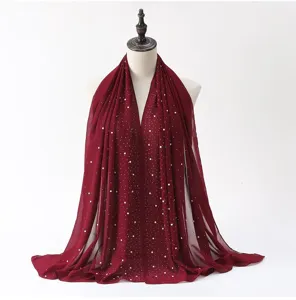 Detailed view of the dark red chiffon hijab scarf adorned with delicate pearl rhinestones.
