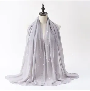 Exquisite grey chiffon hijab with delicate pearl details, graceful drape and soft fabric texture.
