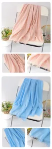 Detailed view of solid color linen scarf, showing soft draped texture and frayed tassel edge.