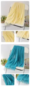 Solid color linen scarf detail view, elegant frayed tassel shawl and beach wrap, soft fabric.