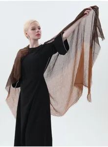 Detailed view of the gradient linen shawl worn by model, showing soft texture and cozy drape.