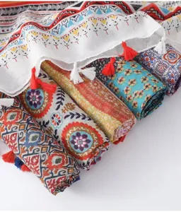 Close-up view of colorful bohemian print tassel scarves showing detailed fabric and texture.