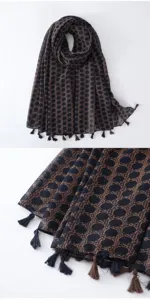 Close up view of soft printed scarf fabric and detailed tassel hem texture design.