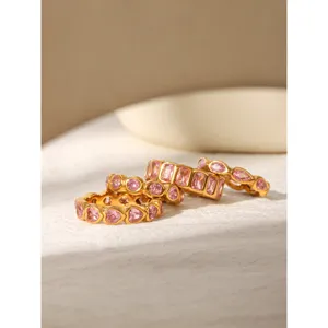 Detailed close-up shot of trendy pink zircon gold rings showcasing delicate setting and fine polish.