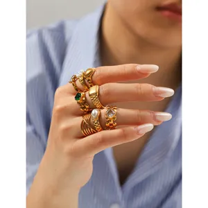 Close-up detail of multi-piece gold titanium steel rings set featuring unique watch-strap design.