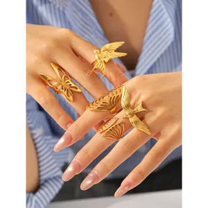 Gold stainless steel flying bird open ring detailed shot, vintage hollow wing design.