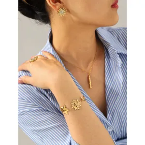 Detailed shot of gold sunflower necklace and sun charm bracelet set, elegant vacation jewelry.