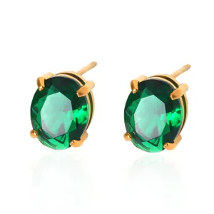 Close-up detail of emerald green zircon stud earrings with gold-plated finish, elegant sparkle.