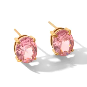 Close-up detail of elegant oval pink cubic zirconia stud earrings with gold setting.