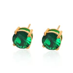 Close-up detail shot of vibrant emerald green round cubic zirconia stud earrings in gold setting.
