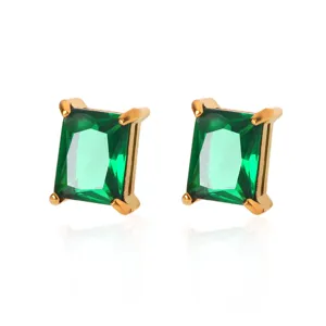 Detailed close-up of emerald-cut green crystal stud earrings with gold-plated setting.